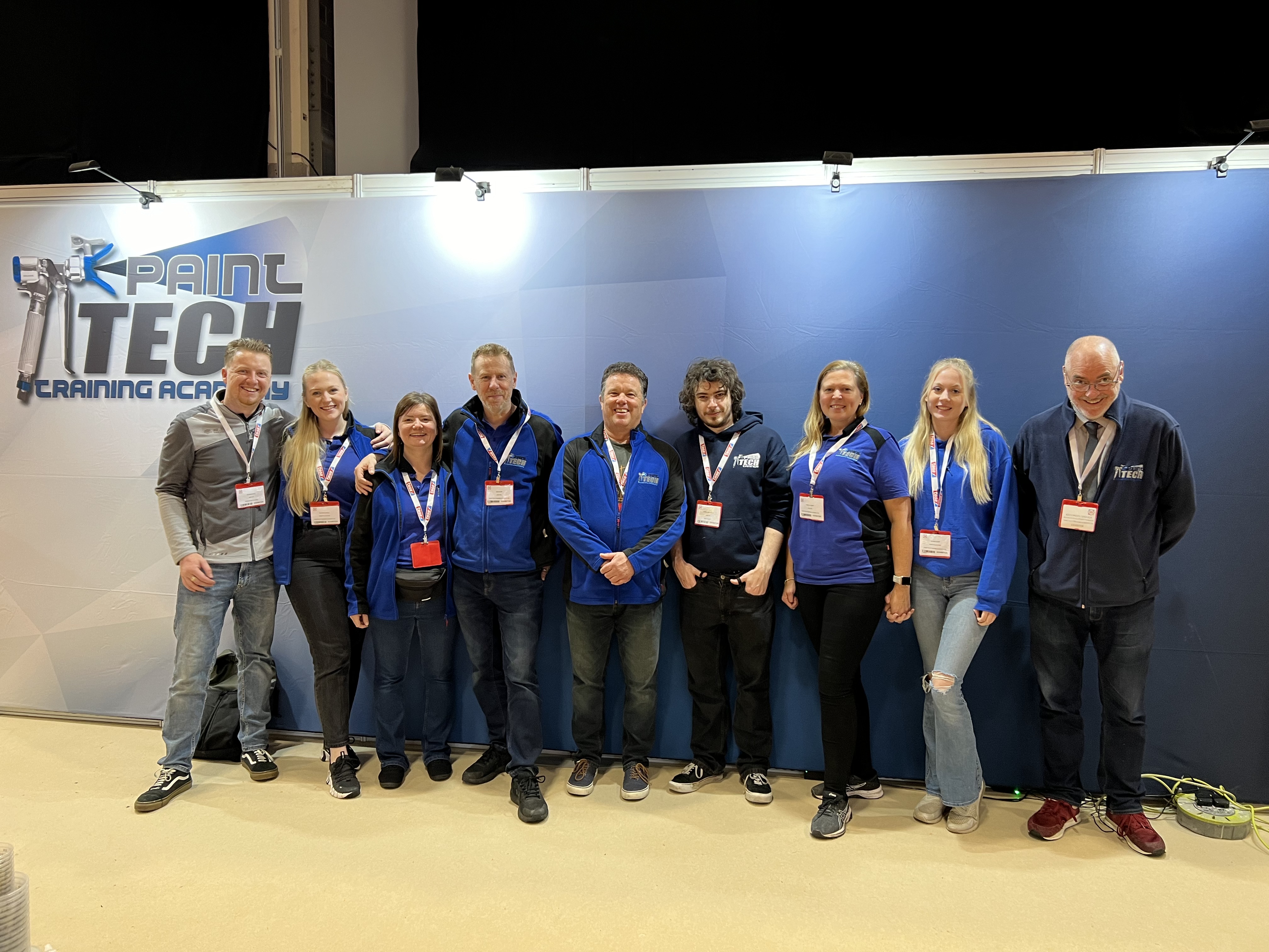 just a photo of the painttech training academy team at the national painting and decorating show